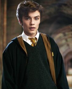 a young man wearing a harry potter outfit and holding a book bag in his hand