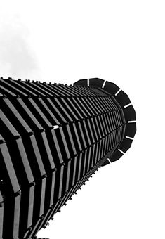 a black and white photo of the top of a building with a clock on it