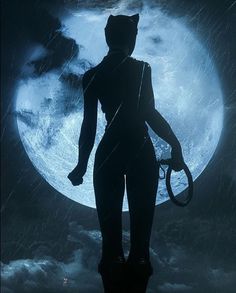 a woman standing in front of a full moon with an umbrella and hat on her head