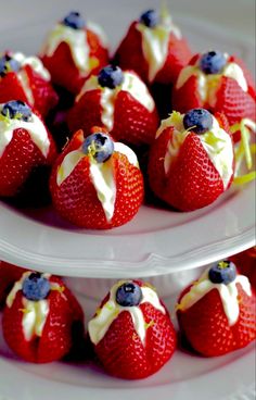 strawberries with white frosting and blueberries on top