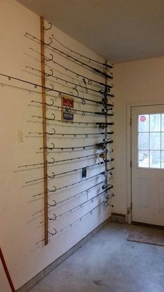 fishing rods are hanging up on the wall in an empty room with no one inside