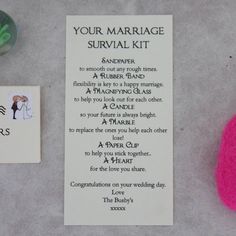 a marriage survival kit next to a pink ball and magnets on a table with the message your marriage survival kit