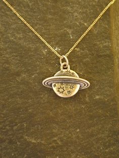 "This solid 3 Dimensional Saturn pendant is 14K Gold. The included chain is a 14K Gold chain. You may choose 16, 18 or 20 inch at the same price. Other length available at sightly higher prices. This Saturn pendant measures 9/16\" tall by 13/16\" across. I hand cast all my pieces using the lost wax casting method. Please ask your needs. You may call me with questions, often I am out so please use my machine. 831-476-3176. Satisfaction Guaranteed! I send items USPS First Class unless otherwise di Sterling Silver Pendant Necklace Stamped 14k, Silver 14k Gold Charm Necklace, Custom Gold Sterling Silver Necklace, Nickel Free, Celestial Style Hallmarked Round Pendant Necklace, Custom Sterling Silver Necklace Stamped 14k, Custom Silver Round Necklace Stamped 14k, Custom Silver Necklace Stamped 14k, Celestial Hallmarked Round Pendant Necklace, Sterling Silver Celestial Necklace With Polished Finish