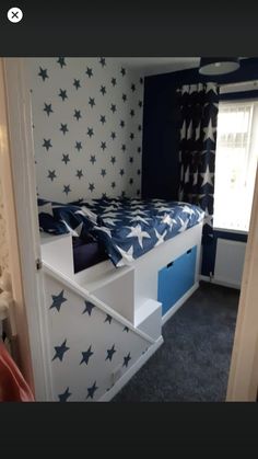 a bedroom with blue and white stars painted on the walls