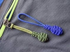 there are two pieces of blue and green rope on the side of a gray jacket