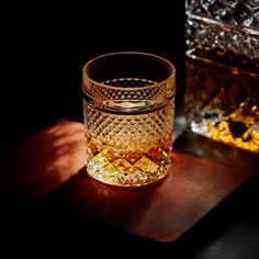 an empty glass sitting on top of a wooden table