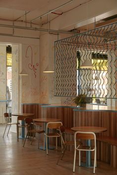 an empty restaurant with wooden tables and chairs