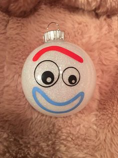 a white ornament with a smiley face on it