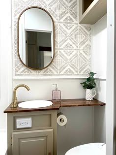 a bathroom with a sink, mirror and toilet