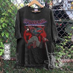 spider - man and the sinisterverse shirt hanging on a fence