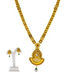 Virani Jewelers presents a gorgeous 22k yellow gold necklace and earring that embodies the grandeur of Indian jewelry. The rich tones of Kundan and emerald are enhanced by the warm antique gold finish, creating a luxurious pieces of Indian jewelry that exudes timeless beauty. Designed with both tradition and modern elegance in mind, this 22k gold necklace amd earring set is perfect for special occasions, bringing a regal touch to any ensemble. Their intricate design ensures it stands out as a wo Gold-plated Chandbali Temple Necklace In Yellow Gold, 22k Yellow Gold Chandbali Kundan Necklace, Heavy 22k Yellow Gold Jewelry Sets, Heavy Yellow Gold Temple Jewelry Sets, Elegant Antique Gold Chandbali Temple Necklace, Heavy Temple Jewelry Sets In Yellow Gold, Traditional 22k Gold Hallmarked Jewelry Sets, Heavy Yellow Gold Jewelry Sets For Diwali, Traditional Gold Dual-tone Temple Necklace