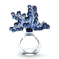 a glass vase with blue flowers in it