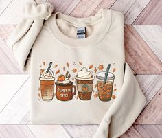 Trendy Fall Coffee Latte Graphic Sweatshirt, Cute Hello Fall Shirt, Womens Fall Vibes Apparel, Unisex Pumpkin Season Sweater, Autumn Leaves Fashion, Fall Teacher Outfit, Preppy Thanksgiving Gifts, Plus Size Spooky Season Halloween Clothing, Christmas Sweatshirt, Iced Coffee Lover Gifts, Pumpkin Spice Shirt This well-loved, cozy pumpkin season sweatshirt is perfect for your favorite fall, autumn, Halloween, or Christmas nights! ✧ SIZING ✧ ⋒ Please check our size chart before placing an order. ⋒ I Fall Crewneck Sweatshirt, Cute Sweaters For Fall, Fall Crewneck, Teacher Outfits Fall, Thanksgiving Sweater, Pumpkin Spice Shirt, Fall Football, Cute Womens, Coffee Sweatshirt