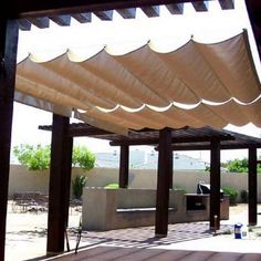 an outdoor covered patio with tables and chairs