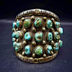 OLD VINTAGE STERLING SILVER and TURQUOISE CUFF BRACELET  DESCRIPTION:  28 specimens of natural turquoise set in a heavy gauge sterling silver cuff with applied raindrops on the oxidized finish. This bracelet will be a cherished addition to your collection of fine vintage Southwestern and Native American jewelry. MEASUREMENTS: Interior of the cuff measures 5 1/4" with an additional 1"  non-adjustable gap. Total circumference:  6 1/4" Measures 2 1/8" straight across the widest part (from wrist bon Antique Turquoise Adjustable Bracelet, Vintage Patina Cuff Bracelet, Vintage Turquoise Bracelets As Gift, Antique Adjustable Turquoise Bracelet, Antique Turquoise Bangle, Handmade Turquoise Vintage Cuff Bracelet, Vintage Turquoise Bangle Cuff Bracelet, Rectangular Turquoise Jewelry For Collectors, Vintage Green Bracelet With Patina