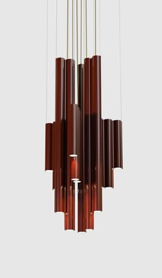 a modern chandelier made out of wood and metal tubes hanging from the ceiling