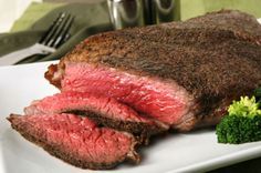 a piece of steak on a plate with broccoli