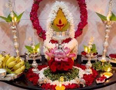 a table topped with lots of different types of flowers and candles on top of it