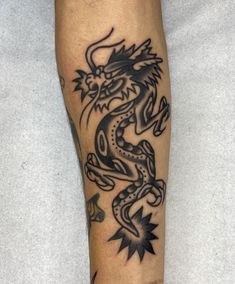 a man with a dragon tattoo on his leg