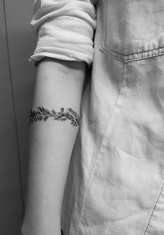 a woman's arm with a small tattoo on the left side of her arm