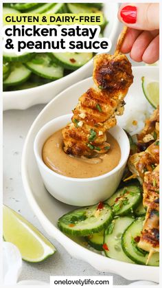 chicken satay and peanut sauce on a plate with cucumbers