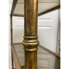 a tall metal pole sitting on top of a glass table