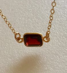 Lovely burgundy red natural garnet gemstone set in 24k gold vermeil bezel. Pendant is 6 x 8 mm and suspended from delicate sparkling 14k gold fill cable chain with matching spring ring clasp. Available in several lengths. Beautiful minimalist necklace makes lovely gift for a January birthday or Valentine sweetheart! Amber Garnet Jewelry As Gift, Amber Garnet Jewelry For Gift, Amber Garnet Jewelry Gift, Gold Oval Garnet Necklaces, Gold Ruby Necklaces With Bezel Setting, Dainty Garnet Gemstone Jewelry, Elegant Amber Birthstone Necklace For Gift, Oval Garnet Gold Necklace, Ruby Necklace With Bezel Setting As Gift