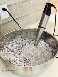 a metal bowl filled with rice and an electric blender