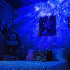 a bedroom with blue walls and stars on the ceiling