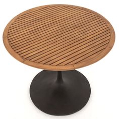 an oval wooden table with black metal base