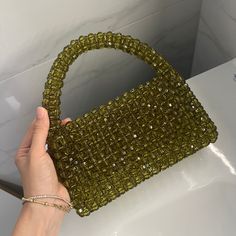 This unique handbag is meticulously designed and crafted with inspiration from nature. Each bead is carefully selected and the bag is entirely hand-stitched. Green crystals symbolize the tranquility and energy of nature. Features: - 🌿 Material: High-quality green crystal beads, durable stitching. - 🌿 Dimensions: Medium : 18cm x 22cm Large : 21cm x 22cm ( size in picture Large size) - 🌿 Use: Perfect for daily use and to complement your style on special occasions. Why Choose This Bag? - 🌿 Uniq Green Beaded Bag, Handmade Green Rectangular Evening Bag, Green Beaded Rectangular Bag, Green Beaded Bags For Daily Use, Green Beaded Pouch Shoulder Bag, Green Beaded Rectangular Evening Bag, Green Square Beaded Bag, Green Beaded Shoulder Bag For Daily Use, Cristal Bag