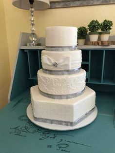 a large white wedding cake sitting on top of a table