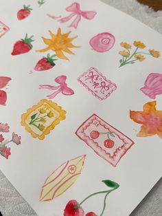 a piece of paper that has some drawings on it with fruit and flowers around it