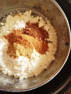 a bowl filled with rice and spices on top of a stove