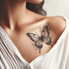 a woman's chest with a butterfly tattoo on her left shoulder and an intricate design