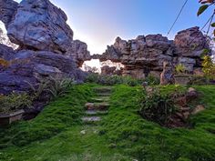 an outdoor area with rocks and green grass