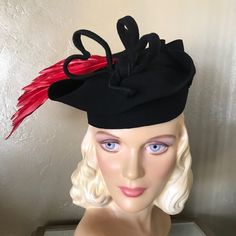 A Fun-Tastic Showstopper Tilt Hat From The Fashionable 1940s'. This Most Creative Black Felt Hat Has A Round Crown, And The Brim Has Been Attached Upwards, Close To The Crown, And Folded In Several Parts, Creating A Stunning Look. The Two Wired Felt "Hearts" At The Top Are So Adorable. To Finish The Look, There Is A Long Red Feather Spray Projecting To The Side. There Is An Elastic Band Attached To The Inside, To Keep The Hat In A Tilted Position. You Will Love This Hat! Tilt Hats Were Popular In The 1930s And 1940s. They Were Worn At An Angle And Held To The Back Of The Head By A Strap, Rigid Ring, Elastic Band Beneath The Hair, Or A Combination Of These. There Is No Label, Indicating It Red Fitted Hat For Costume, Red Fitted Vintage Top Hat, Vintage Red Hat For Fall, Red Fitted Felt Hat For Formal Occasions, Formal Red Fitted Felt Hat, Red Vintage Costume Hat, Vintage Fitted Felt Hat For Evening, Black Felt Hat, Straw Flowers