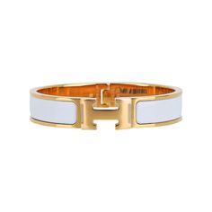 Hermes Clic H Bracelet featured in white Enamel.Set in Gold plated hardware.Chic, modern and unmistakably Hermes!A hinged band allows the H to swivel and open the bracelet.Comes with pouch and signature Hermes box.NEW or NEVER WORN.final saleSIZE: PM or SmallBRACELET MEASURES: DIAMETER 2.25"HEIGHT 0.47" CONDITION:NEW or NEVER WORN Modern Adjustable White Bangle, White Timeless Bracelets With Polished Finish, Timeless White Bracelets With Polished Finish, Timeless White Bracelet With Polished Finish, Modern Bracelets With Gold-tone Hardware, Luxury White Cuff Bracelet, Luxury White Bracelets With Polished Finish, Modern White Bracelet With Strap, Designer White Bangle Bracelets