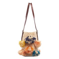 DESCRIPTION The colorful Rainbow Pom Pom straw designer bag is handcrafted in Ghana from natural and dyed raffia. The luxury African handbag has two sturdy, adjustable top handles that are made of 100% leather, making this purse convenient to carry. The linen lined interior has one inner pocket for organization. This woven straw designer bag is a stylish shoulder purse to carry in the summer or to bring to a poolside evening gathering. DETAILS Handmade in Ghana Measurements: H9'' x W14'' Materia Rainbow Bag, Colorful Handbags, Crochet Purse, Crochet Purse Patterns, Woven Raffia, Traditional Weaving, Raffia Bag, Purse Patterns, African Design