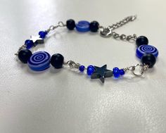 Blue beaded swirl bracelet (unisex sizing) ~Sizing~ * Small fits: 14cm-18cm * Medium fits: 17.5cm - 22.5cm * Large fits: 22cm - 26cm   *If you do not see your size above please feel free to message or add on order for custom sizing!*  Bracelet is made of glass beads, and nickel free chain Trendy Blue Charm Bracelet For Gift, Trendy Blue Charm Bracelet Gift, Trendy Blue Charm Bracelet With Round Beads, Casual Blue Charm Bracelet With Round Beads, Trendy Blue Beaded Charm Bracelet, Blue Bracelet Ideas, Swirl Bracelet, Life Vibes, Beaded Charm Bracelet