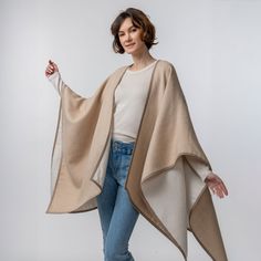 Our Vienna Cape, a true statement piece for the modern fashion enthusiast. Designed with a double-weave construction and adorned with sophisticated alcantara trim, this reversible cape radiates elegance and style from every angle. The Vienna Cape effortlessly elevates your outfit with its sleek silhouette. Embrace the look of modern sophistication with the Vienna Cape, a wardrobe essential that seamlessly transitions from day to night. Dimensions: 50 in. x 30 in. Materials: 100% baby alpaca, 100 Suri Alpaca, Beautiful Farm, Heavy Knit, Baby Alpaca, Alpaca Wool, Fair Trade, Modern Fashion, Black Charcoal, Vienna