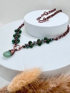 The Green Aventurine Antiqued Copper necklace marries elegance with vintage charm, exuding a timeless allure that captivates admirers. Crafted with meticulous attention to detail, this necklace intertwines the soft, soothing hues of green with the rustic allure of antiqued copper. The natural variation in the stones adds a touch of uniqueness to every piece, making the necklace a one-of-a-kind treasure. The beads are carefully strung along a durable yet flexible wire, allowing for comfortable wear and graceful movement.  The antiqued copper accents infuse the necklace with a sense of old-world charm and sophistication. The weathered finish lends a distinctive character to the piece, reminiscent of heirloom jewelry passed down through generations. Intricate copper detailing, meticulously cr Oxidised Necklace, Heirloom Jewelry, Graceful Movement, Copper Jewellery, Oxidized Necklace, Copper Accents, Heirlooms Jewelry, Necklace Gemstone, Copper Necklace