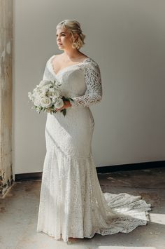 a woman in a wedding dress holding a bouquet