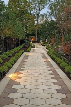 an outdoor walkway is lit up with lights