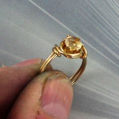 "THE BEAUTY OF YELLOW CITRINE 14kt rolled gold RING HOLDING A 6MM YELLOW CITRINE Pictures do not show the true beauty of the STONE made to size ----- custom hand crafted setting Size 5 to 8 (see chart) In a sculpted one of kind handcrafted 14kt rolled gold setting ABOUT MY JEWELRY This is wire sculpted Jewelry all made by hand. It is created wire by wire with the best metals and material in the business. Such as Sterling Silver, and precious stones, and 14kt rolled gold.Gold. Each item is a smal Gold Citrine Rings For Jewelry Making, Adjustable Gold Solitaire Jewelry, Gold Citrine Promise Ring, Gold Rings With Birthstone For Jewelry Making, Gold Citrine Birthstone Ring For Promise, Gold Citrine Birthstone Promise Ring, Adjustable Gold Citrine Rings, Adjustable Gold Birthstone Ring With Prong Setting, Gold Citrine Ring With Prong Setting