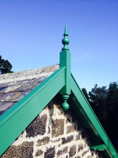 an old brick building with a green roof