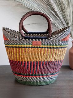 This striking large shopping basket is sure to be an eye-catcher wherever you go for trips to the farmer's market or the perfect Summer beach bag. The handles of the basket are finished with sustainable leather for comfort and durability. Made exclusively for Lola & Mawu by the weavers of the Bolgatanga area, Northern Ghana. Lola & Mawu's baskets are fair trade and every purchase provides meaningful income to the makers. Shopper Marketing, Summer Beach Bag, African Goddess, Bolga Basket, Basket With Handles, Local Farmers Market, Sustainable Leather, Market Baskets, Farmer's Market