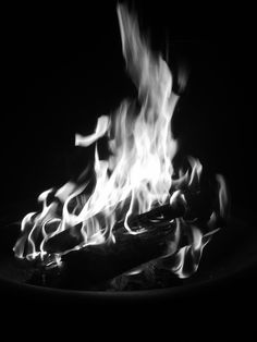 the fire is blazing in the black and white photo