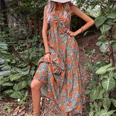 Beautiful Top Knot Cami Maxi Bottom Tier For Flare Front Top Knot In Cleavage Ruched & Ruffled Cami Straps Large Blue Orange & Green Floral Pattern Perfect To Relax At A Bbq/Block Party Beach Day! Orange Boho Print Maxi Dress For Summer, Spring Orange Boho Print Maxi Dress, Orange Printed Bohemian Sundress, Orange Bohemian Printed Sundress, Orange V-neck Bohemian Sundress, Orange Bohemian V-neck Sundress, Bohemian Orange Printed Sundress, Bohemian Orange V-neck Sundress, Orange Flowy Bohemian Sundress