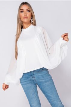 Get your transitional collections all stocked up with our range of new season tops. This high neck blouse featuring batwing chiffon sleeves can be styled with ripped jeans & heeled boots for an effortless chic look! high neck blouse batwing chiffon sleeves mid length regular fit approx length top is 56cm based on a UK size 10 model is 5ft 7" & wears UK size 8/US size 4 95% polyester 5% elastane machine washable Made in Italy Chic High Neck Blouse For Fall, Luxury Elegant Batwing Sleeve Blouse, Chic Batwing Sleeve Blouse For Layering, Trendy High Neck Blouse For Spring, Chic High Neck Fall Blouse, Billowy Blouse With Balloon Pleated Sleeves, Chic Billowy Blouse With Gathered Sleeves, Luxury Batwing Sleeve Blouse, White Billowy Tops With Gathered Sleeves